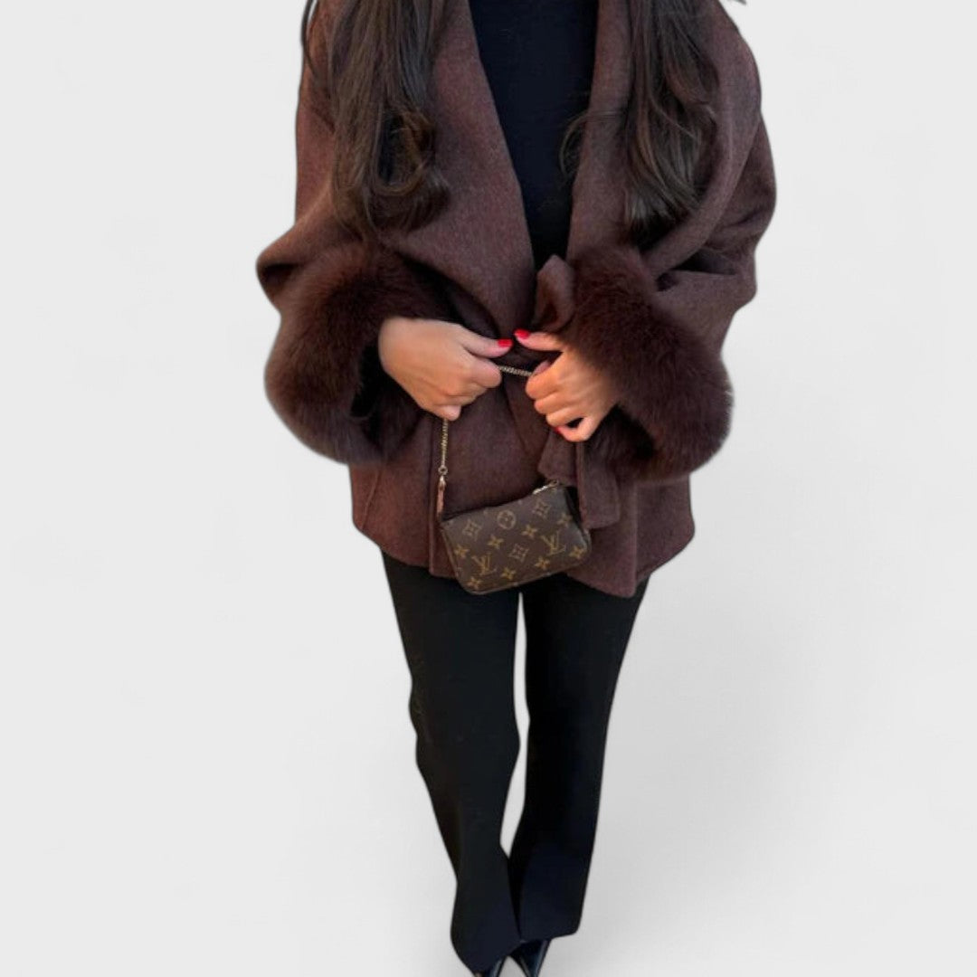 Luxurious women's winter coat, long style with rich faux fur elements, offering warmth and sophistication.