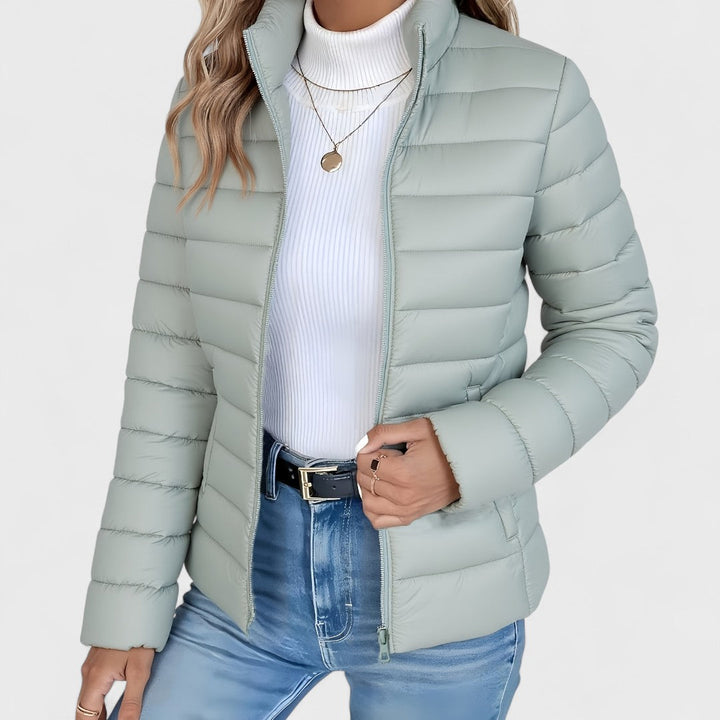 Women's high collar longline quilted jacket, perfect for autumn wear, offering elegance and warmth.