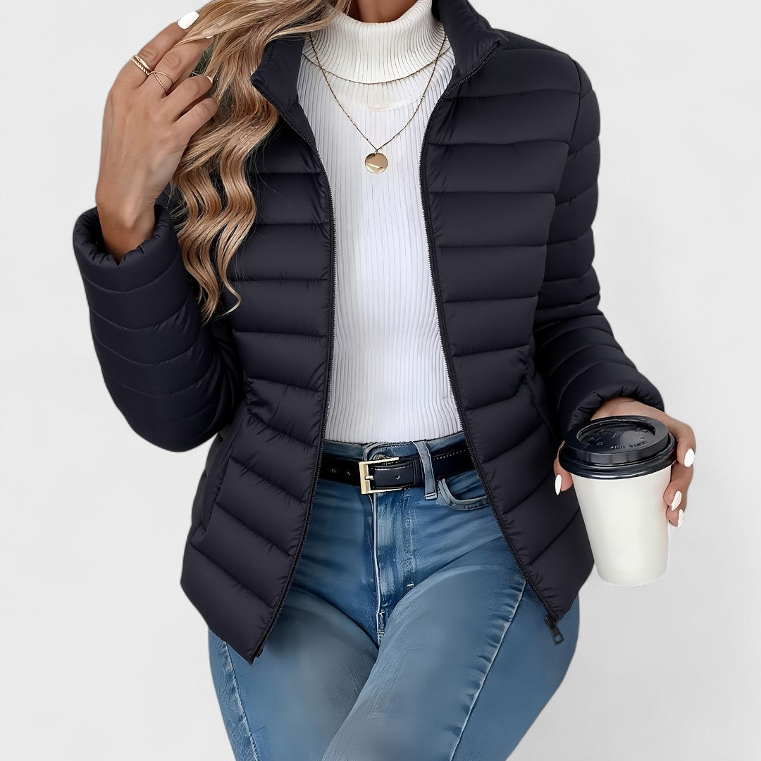 Stylish women's longline quilted jacket with a high collar, ideal for cold weather, an elegant winter coat.