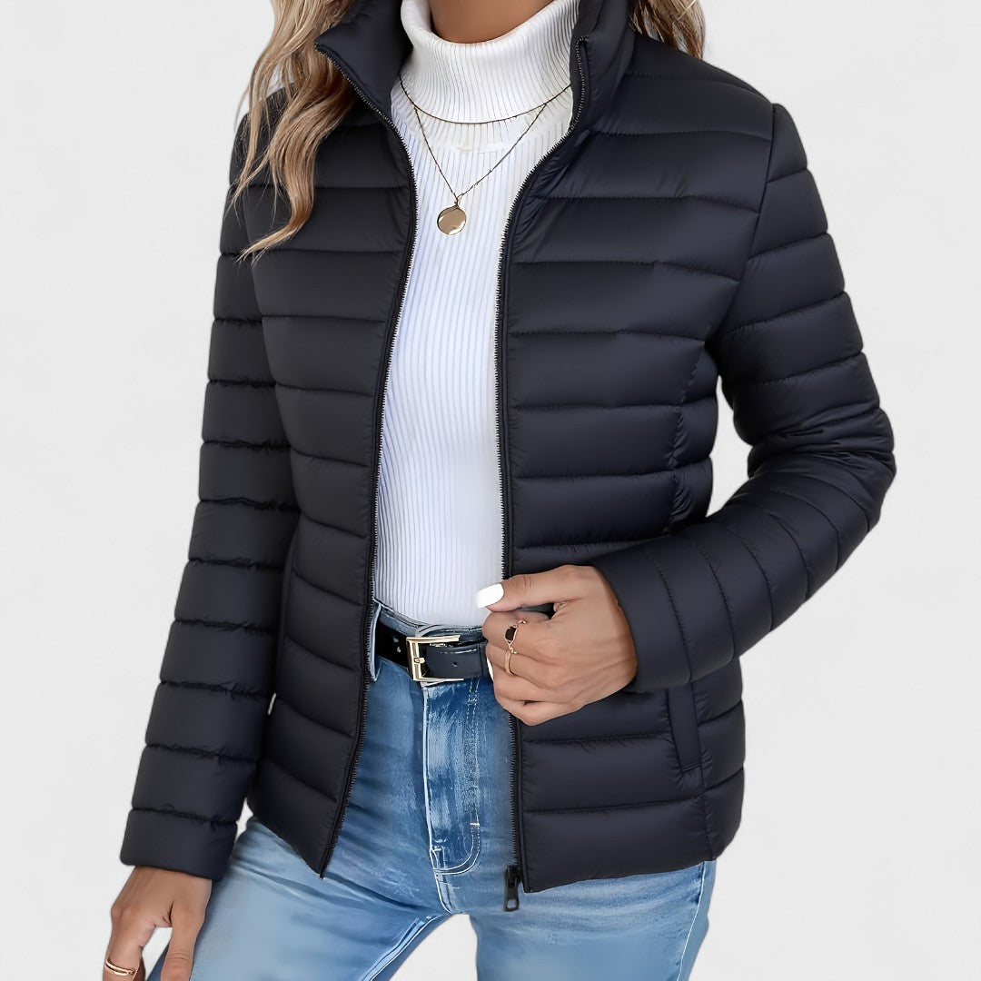 Fashionable women's longline quilted jacket featuring a high collar, a lightweight yet warm autumn essential.