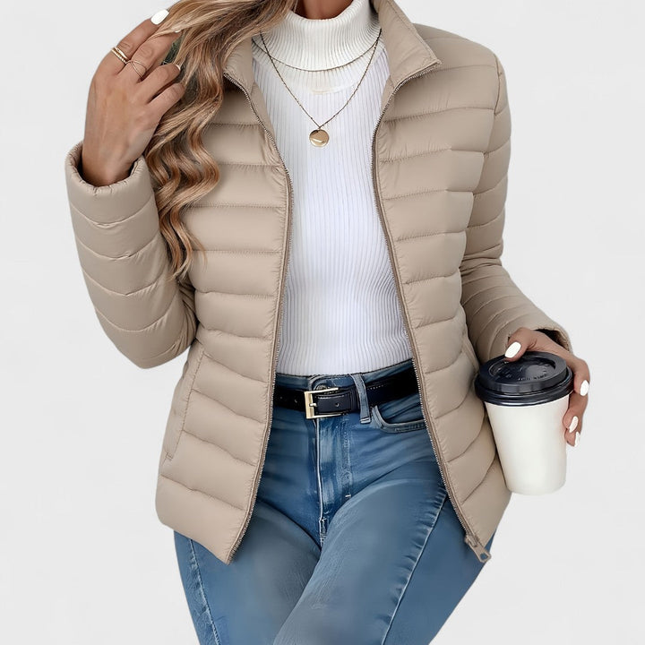 Classic women's longline quilted jacket with a protective high collar, perfect elegant outerwear for winter.
