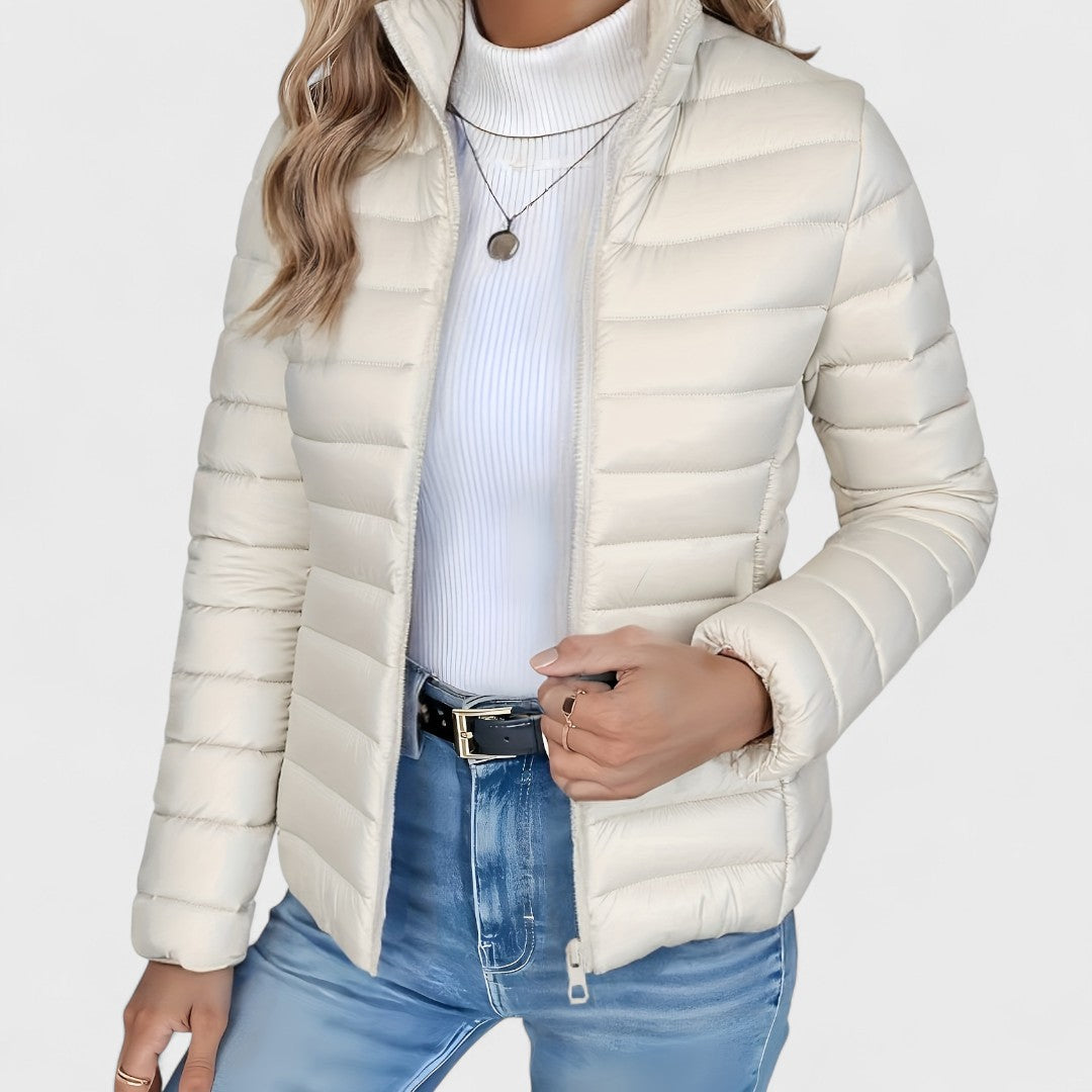 Modern women's longline quilted jacket, high collar design, a versatile and lightweight option for autumn.