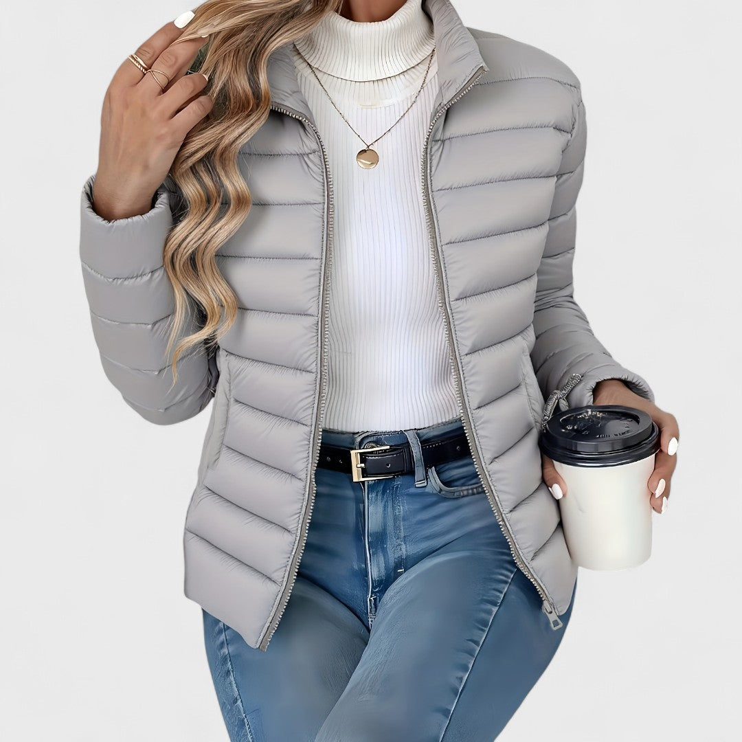 Chic women's longline quilted jacket with a high collar, a top pick for stylish and warm winter outerwear.