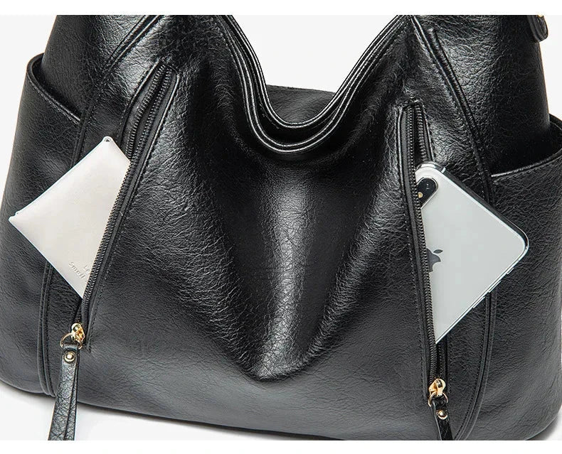 Profile view of a women's vegan leather shoulder bag, demonstrating its slim silhouette