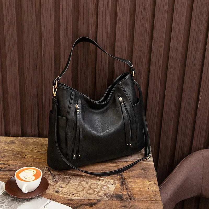 Stylish women's vegan leather shoulder bag with gold hardware, a versatile fashion accessory