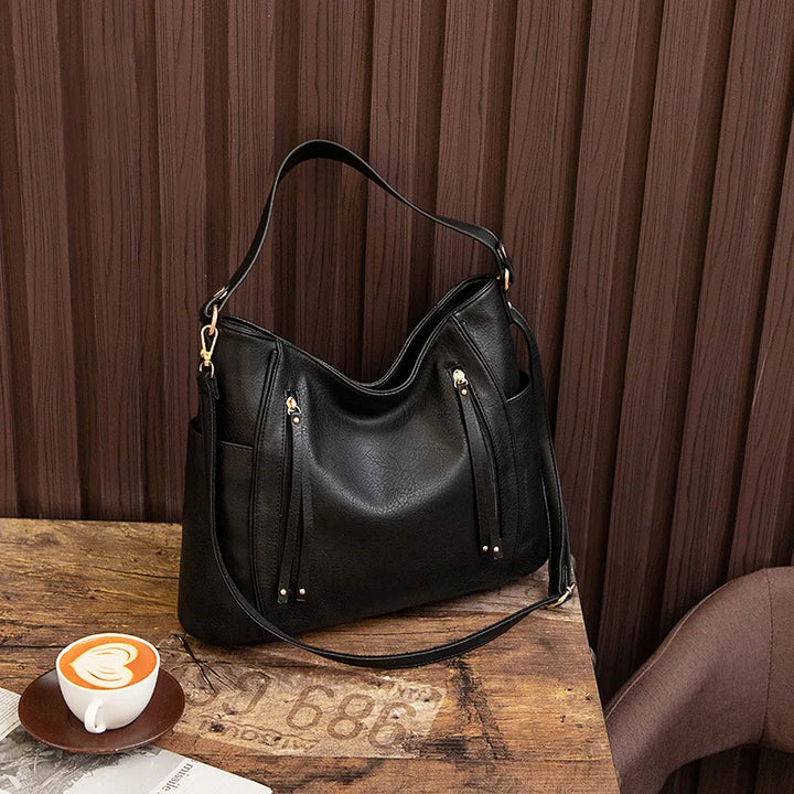 Stylish women's vegan leather shoulder bag with gold hardware, a versatile fashion accessory