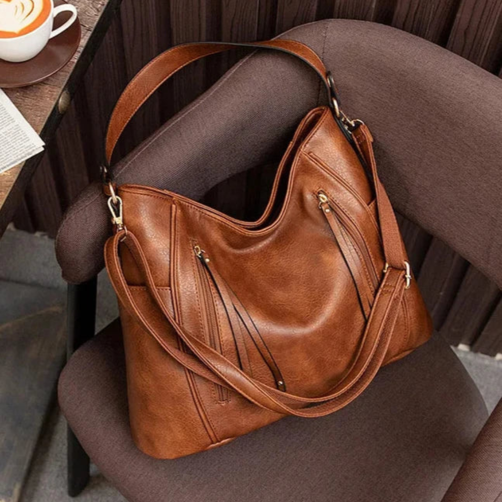 Close-up of a women's luxe vegan leather shoulder bag texture, showcasing its premium feel