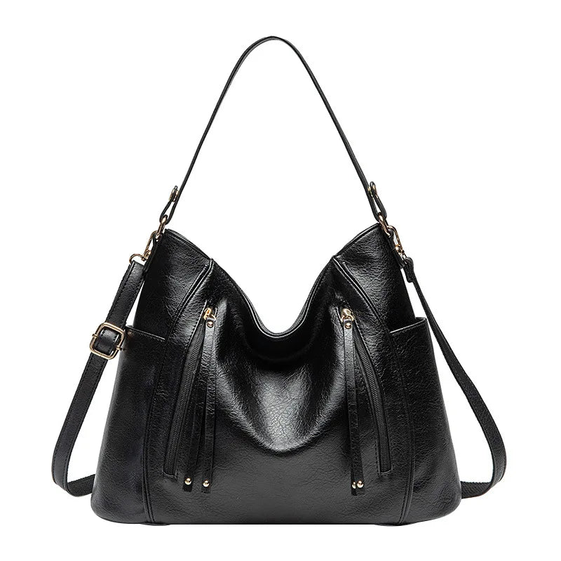Detail shot of the clasp on a women's luxe vegan leather shoulder bag, secure and chic