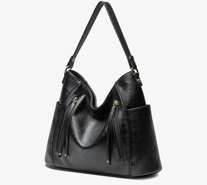 Women's vegan leather shoulder bag featuring an adjustable strap for comfortable wear