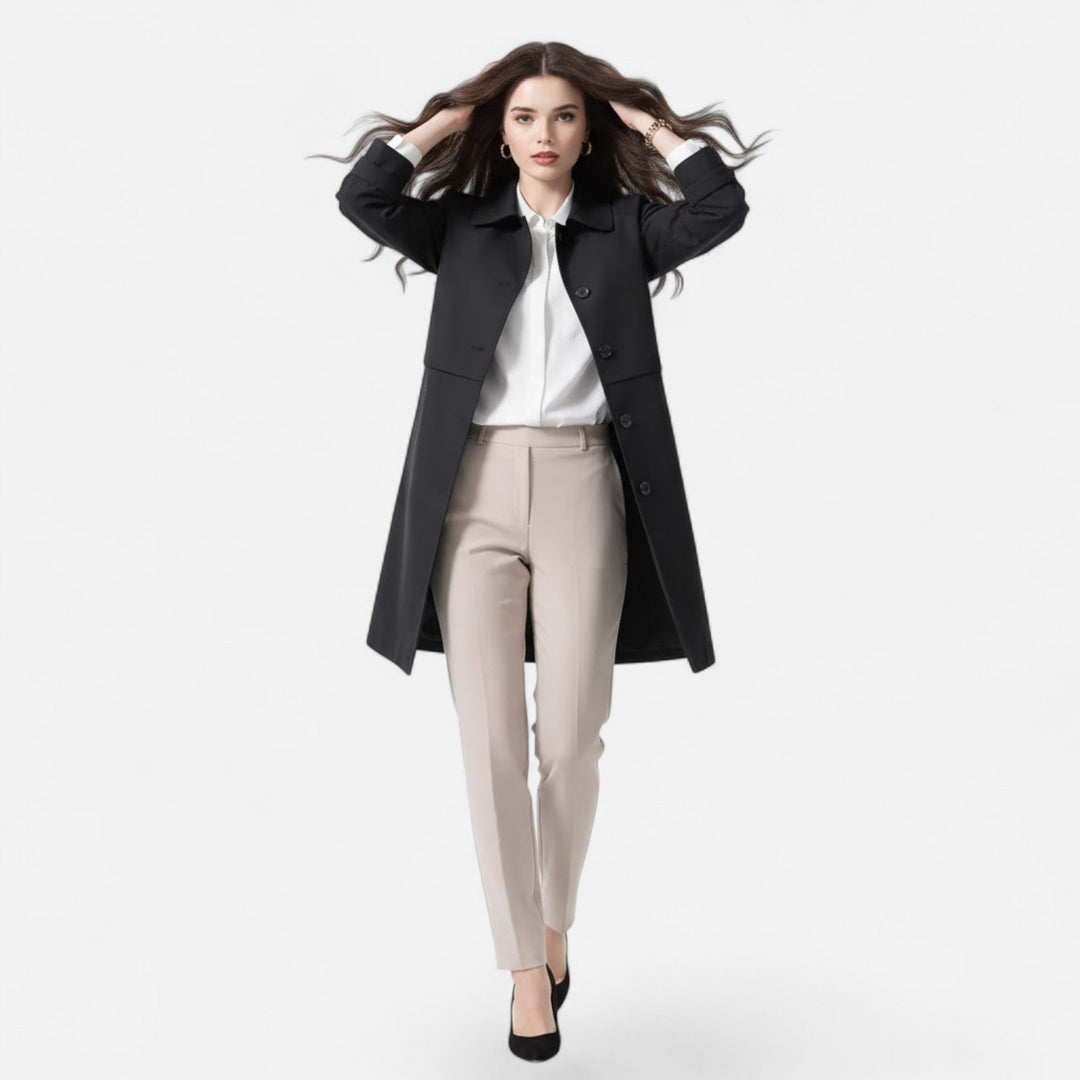 Navy blue women's mid-length trench coat, ideal for winter layering or a spring jacket. Sophisticated style.