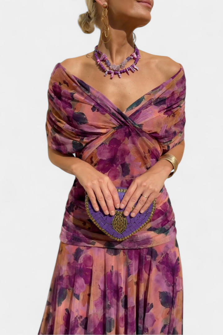 Draped fabric of a women's off-shoulder ruched maxi dress, conveying flowy elegance