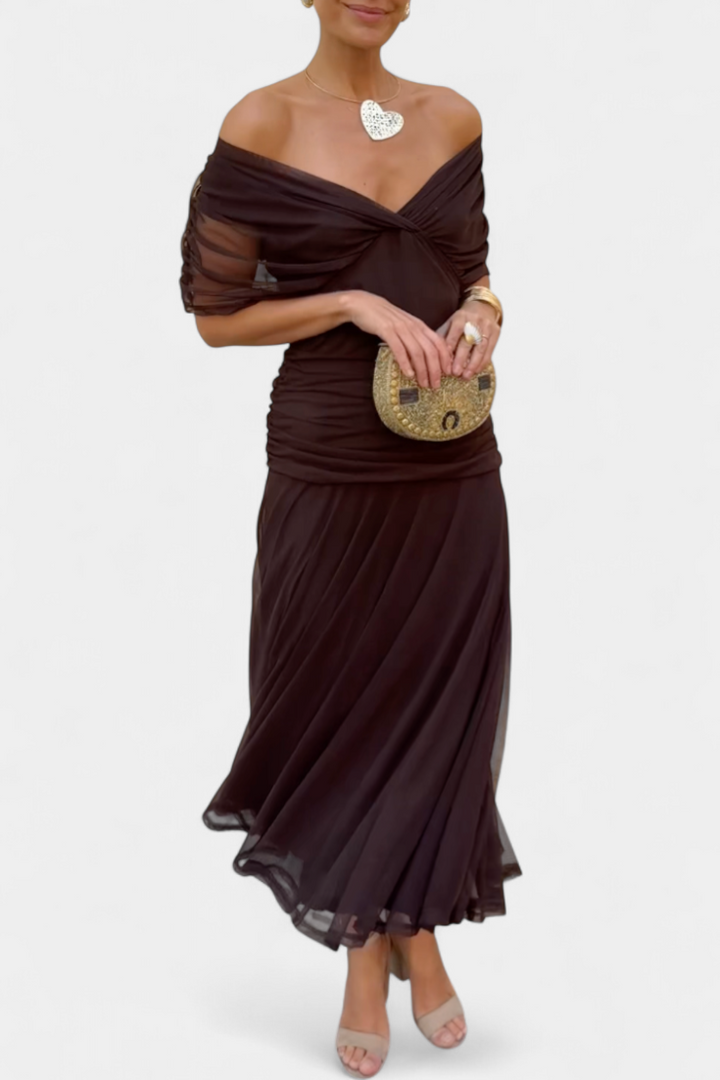 Side profile of a flowy off-shoulder maxi dress, highlighting its elegant drape and ruched design