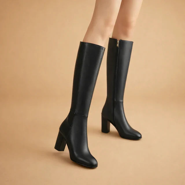 Elegant beige over-the-knee high heel boots. Women's chic long boots for stylish winter fashion.