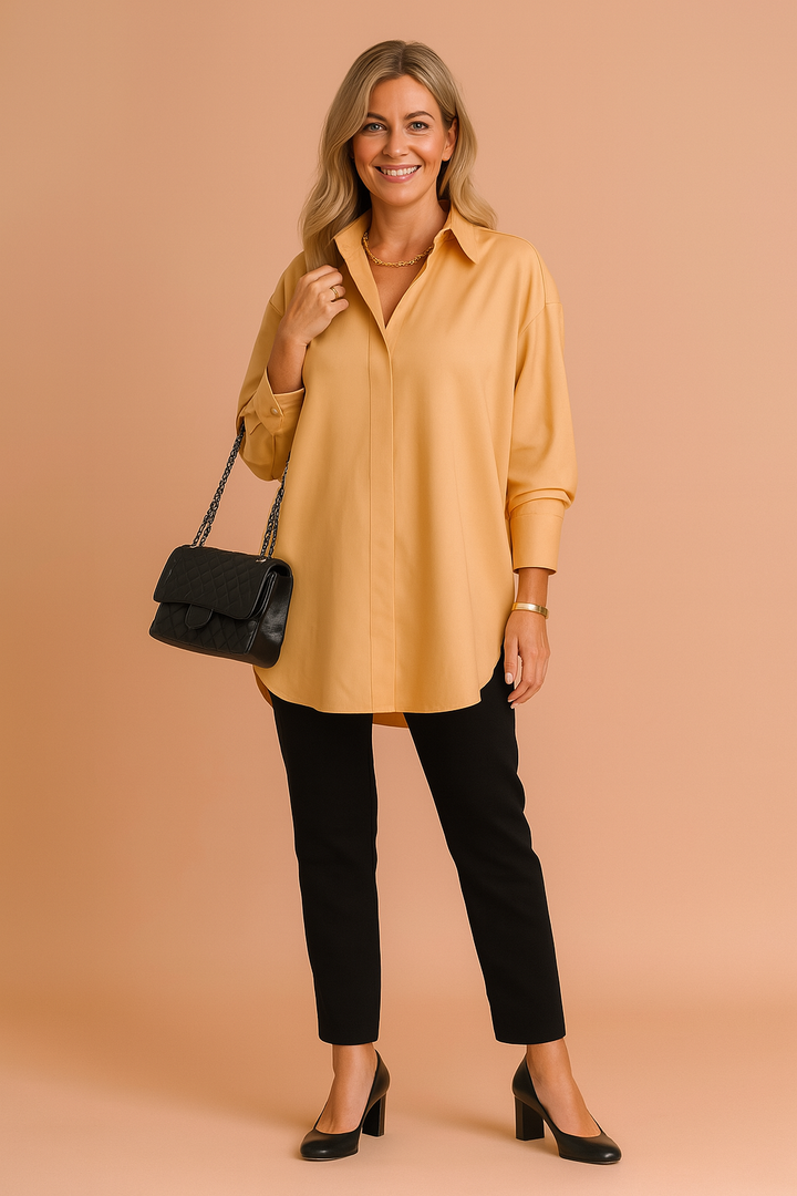 Stylish women's oversized blouse, a modern long-sleeve top. Offers elegant comfort for both casual and workwear fashion.