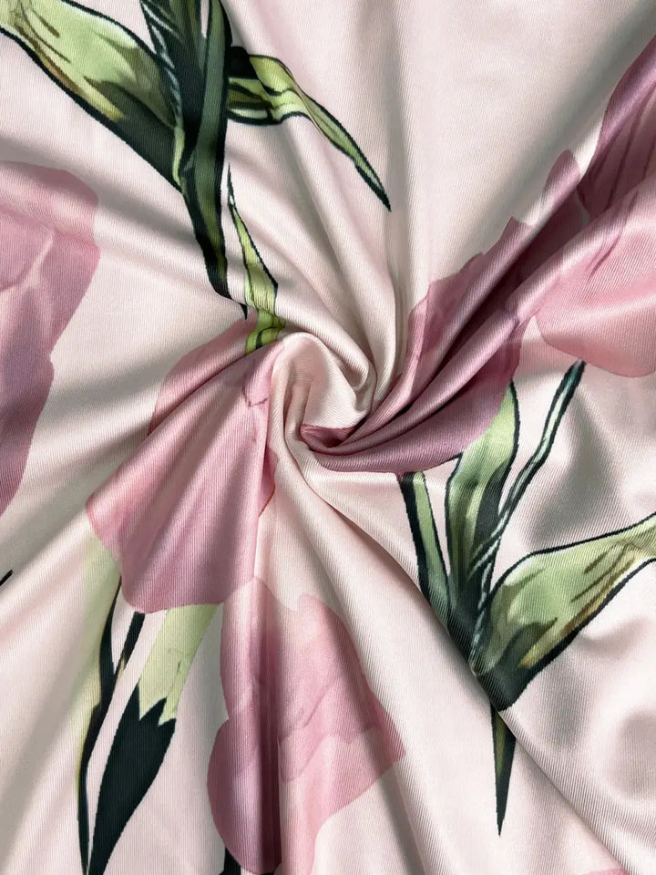 Close-up of the floral pattern on a women's elegant pink maxi dress and jacket set.