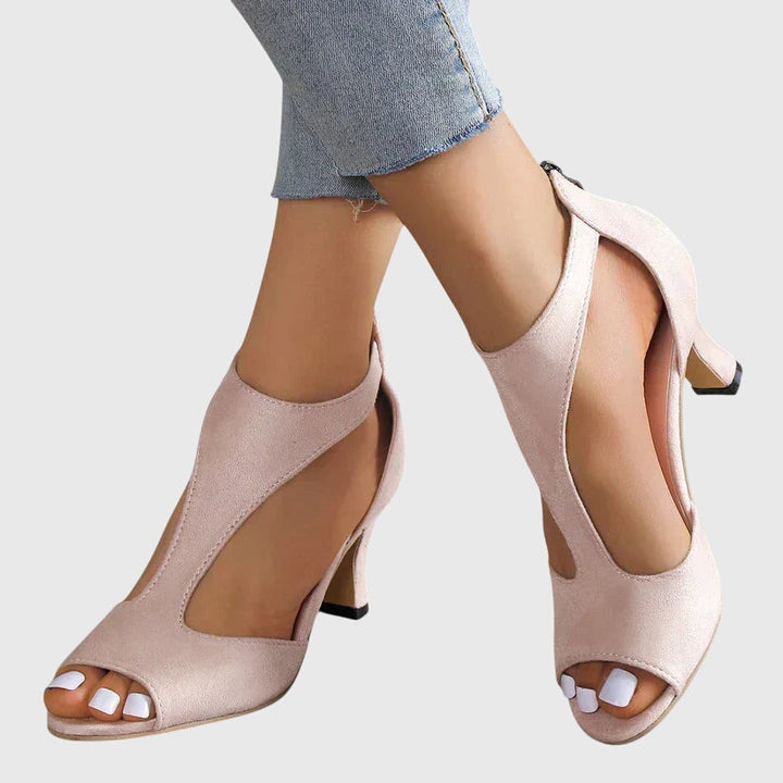 Elegant women's pink strappy open toe stiletto heels, perfect for summer parties. View from the front.
