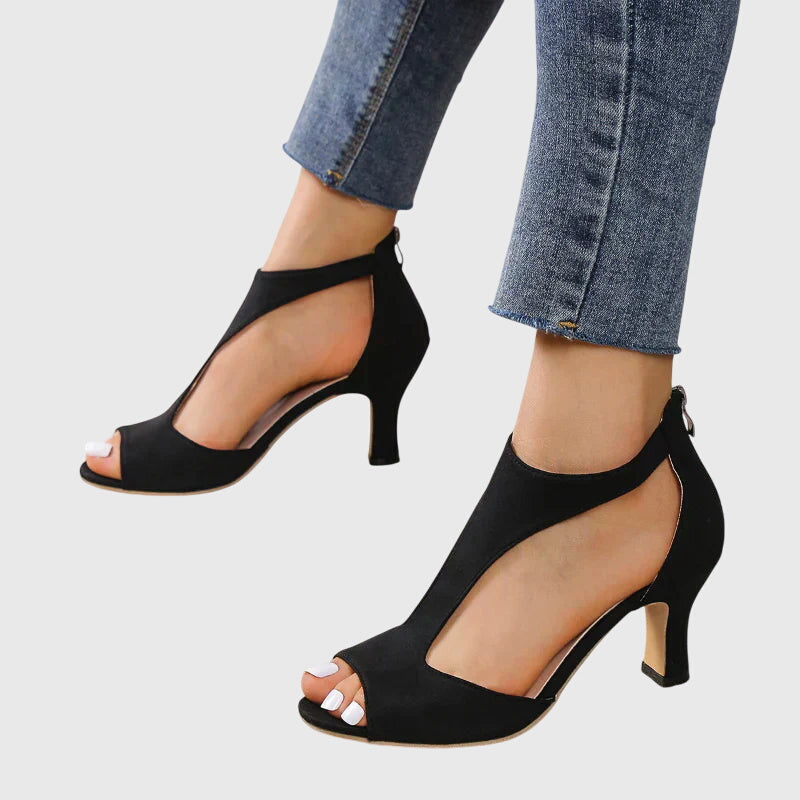 Bottom view of women's strappy open toe stiletto heels, showing the sole and heel for stability.