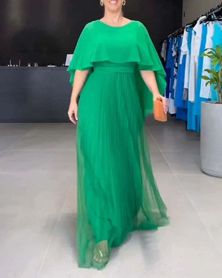 Stylish women's evening wear: a pleated cape dress, ideal for sophisticated events and occasions.