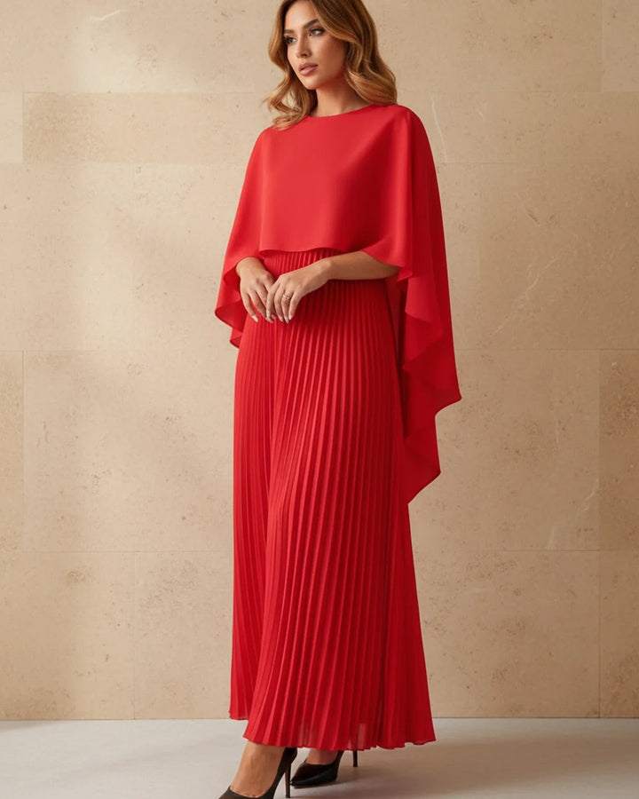 Flowing women's pleated maxi dress with a sophisticated cape, an elegant wedding guest or formal evening gown.