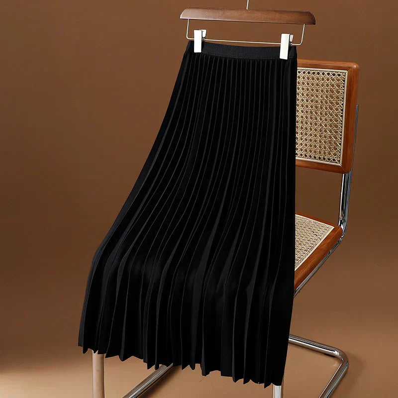 Elegant women's pleated maxi skirt in light color, perfect for spring fashion.