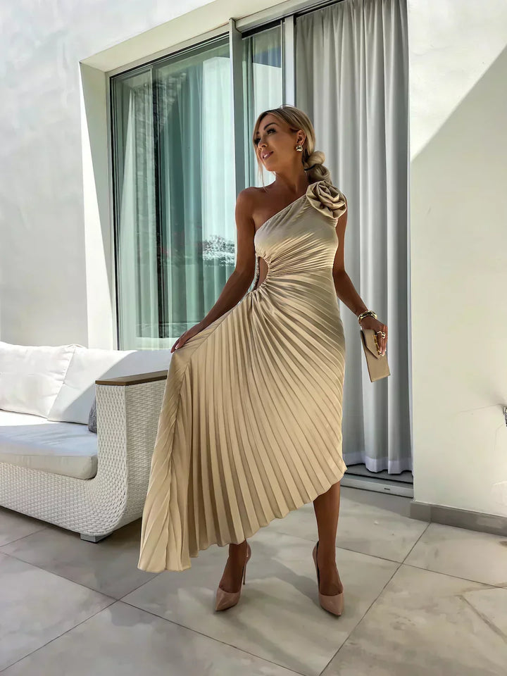 Model posing in a women's elegant pleated one shoulder midi dress, showcasing its flattering fit.