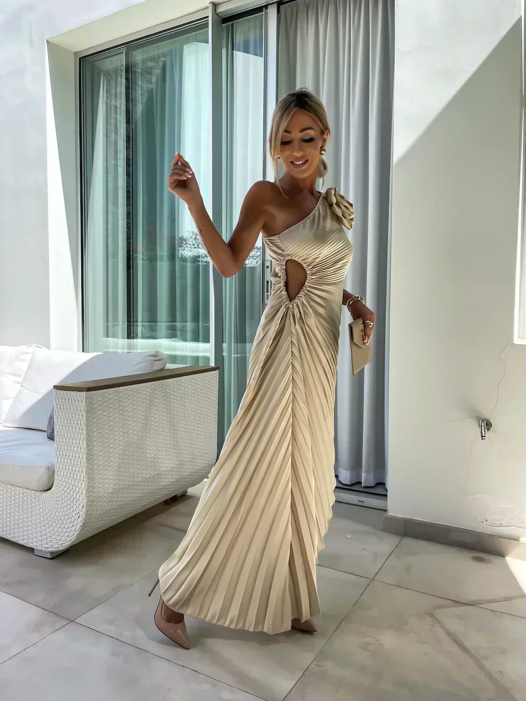Women's flattering pleated one shoulder midi dress in a soft coral, perfect for spring or summer events.