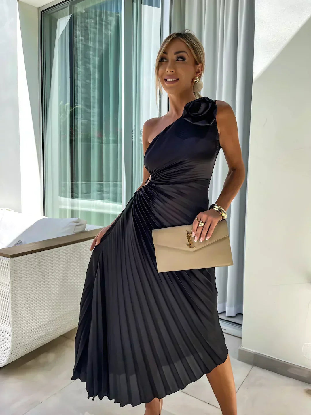 Back view of a women's pleated one shoulder midi dress, highlighting the elegant silhouette.