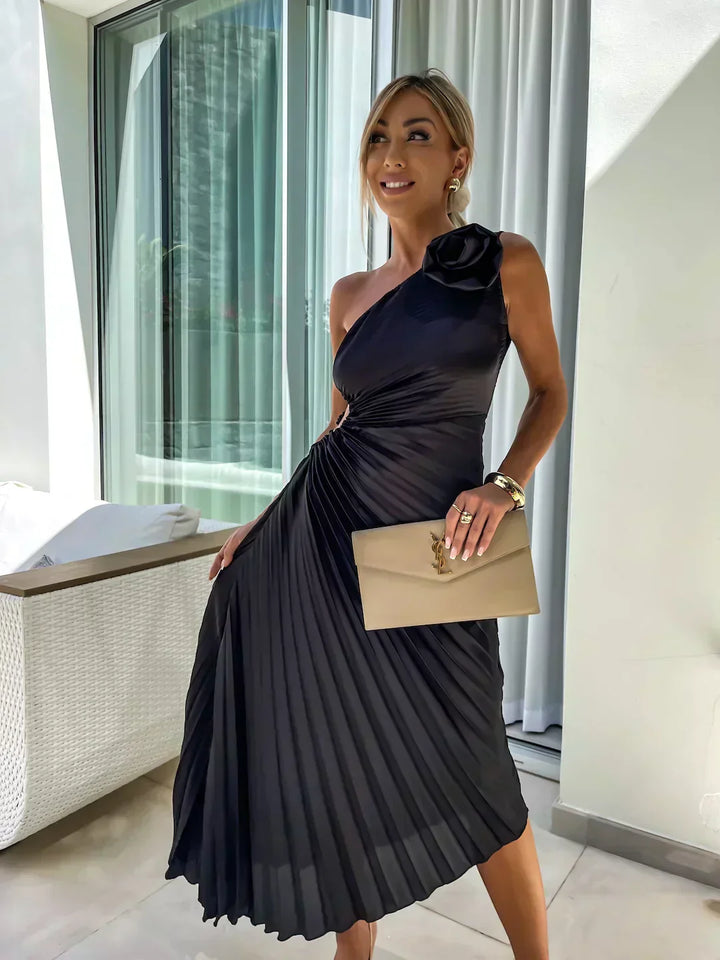 Back view of a women's pleated one shoulder midi dress, highlighting the elegant silhouette.