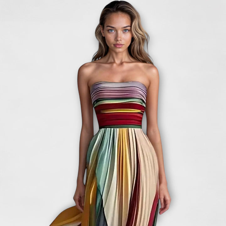 Stylish women's strapless pleated mini dress in a rainbow spectrum, ideal as a colorful party dress.