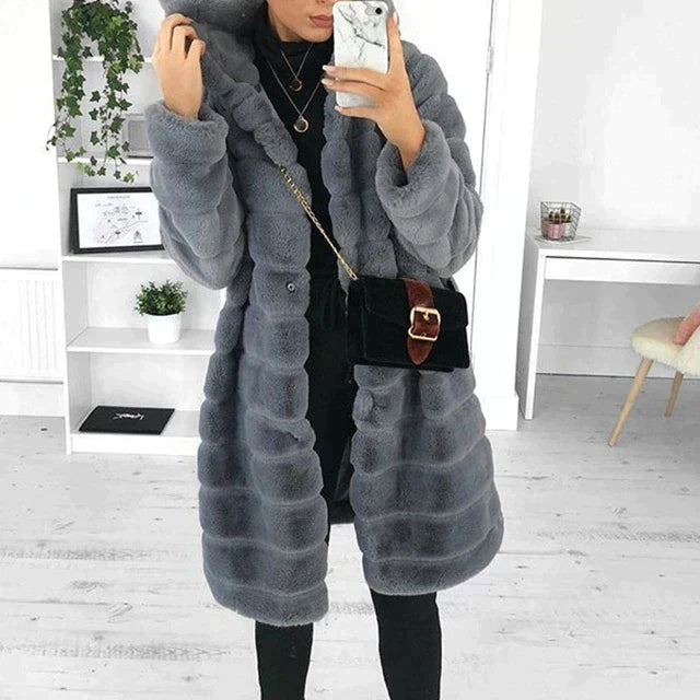 Elegant women's plush longline faux fur coat, ideal warm winter outerwear fashion.