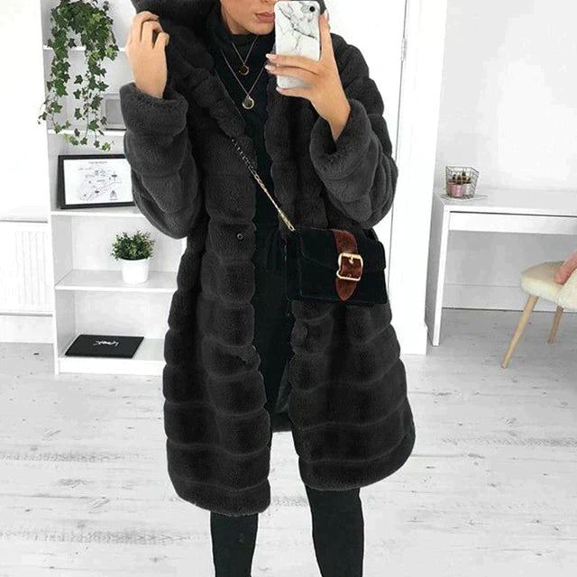 Women's faux fur longline coat in plush material, stylish and warm winter outerwear.