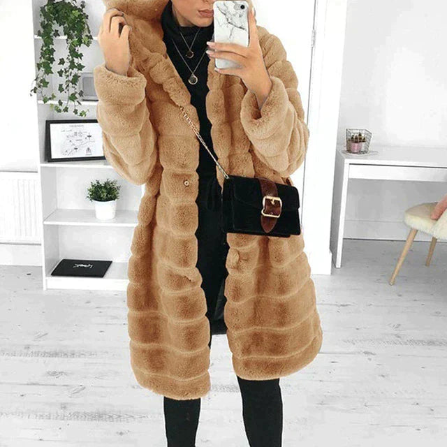 Fashionable women's elegant longline faux fur coat, a cozy and plush winter outerwear.