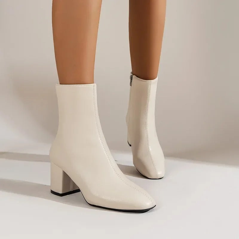 Modern women's pointed toe ankle boots with comfortable block heel, enhancing elegant or casual looks.