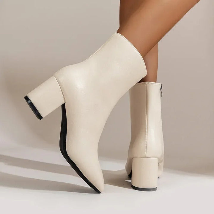 Elegant women's ankle boots, pointed toe design & sturdy block heel for fashionable comfort.