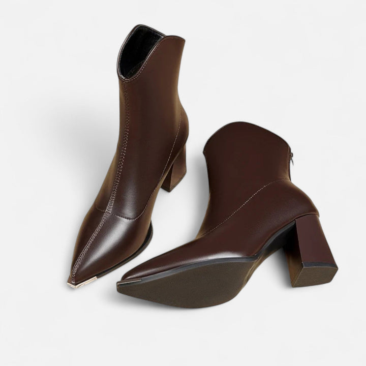Elegant women's pointed-toe Chelsea boots. Chic ankle footwear, perfect for fall and winter fashion comfort.