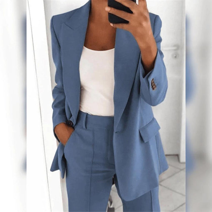 Stylish women's two-piece professional pant suit with fitted blazer, perfect for formal business occasions.