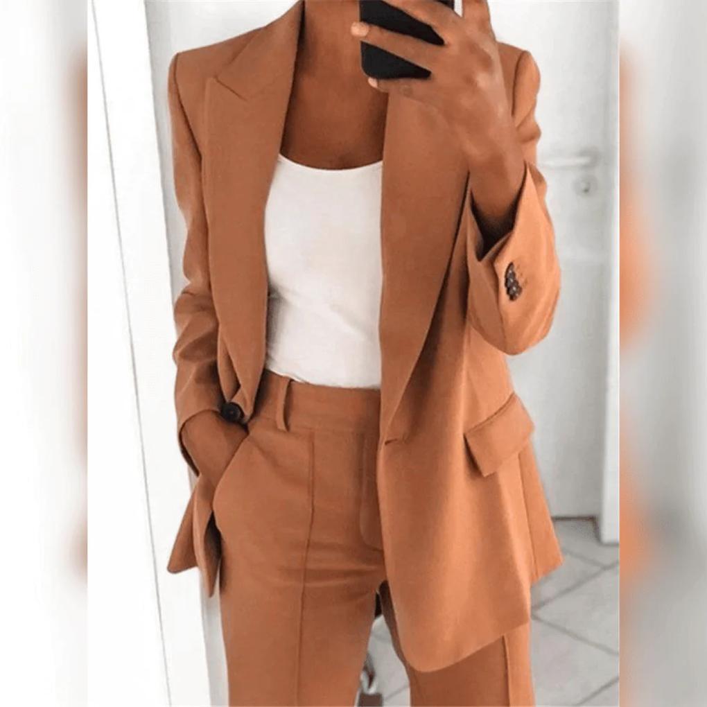 Full-body image of a woman wearing a sophisticated professional blazer and pant suit set, ready for work.