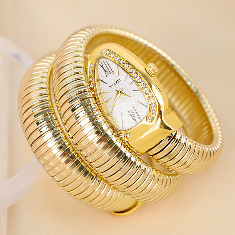 Stylish women's gold snake quartz watch with a matching elegant bracelet set.