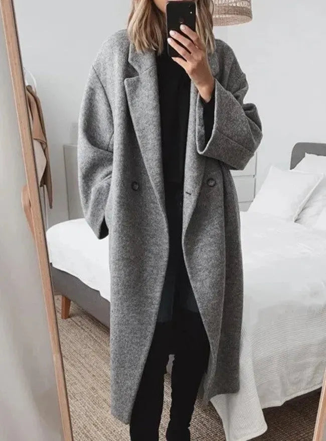 Elegant women's relaxed fit long double-breasted coat in a chic winter style.