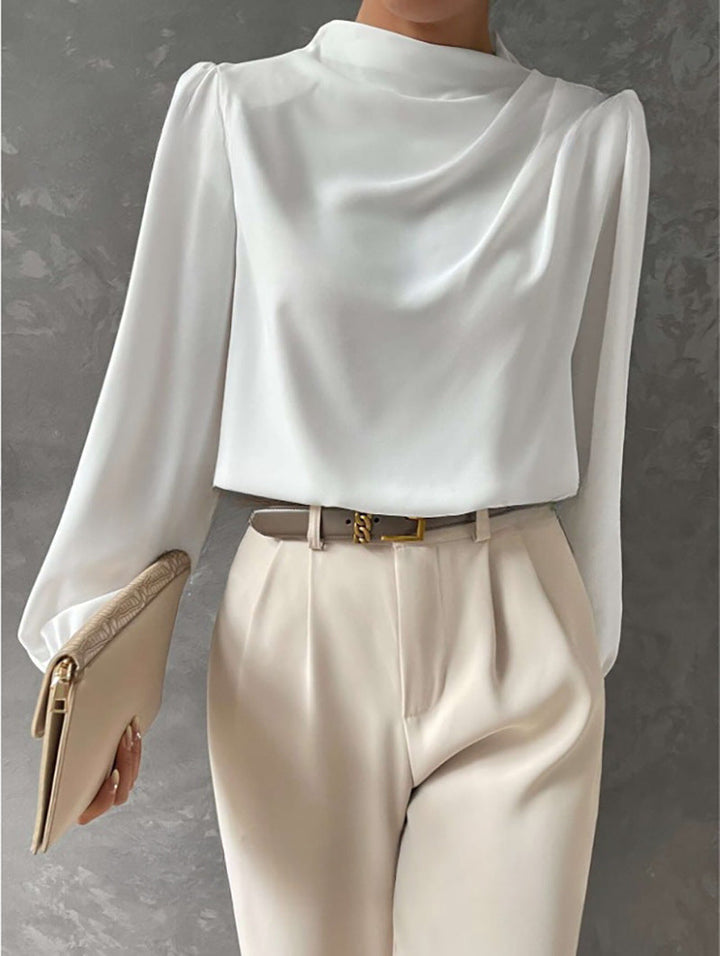 Closeup of the fabric texture of a womens elegant relaxed fit chiffon long sleeve blouse.