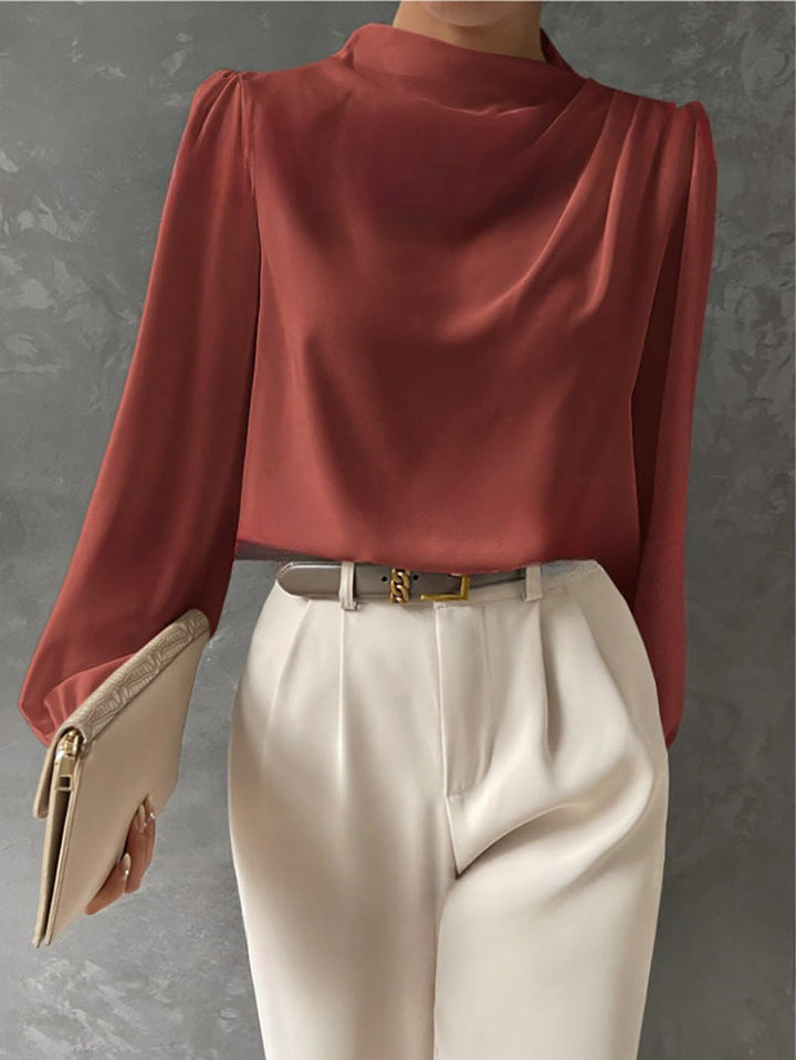 Model wearing a flowy, relaxed fit long sleeve blouse, showcasing its elegant and casual style for women.