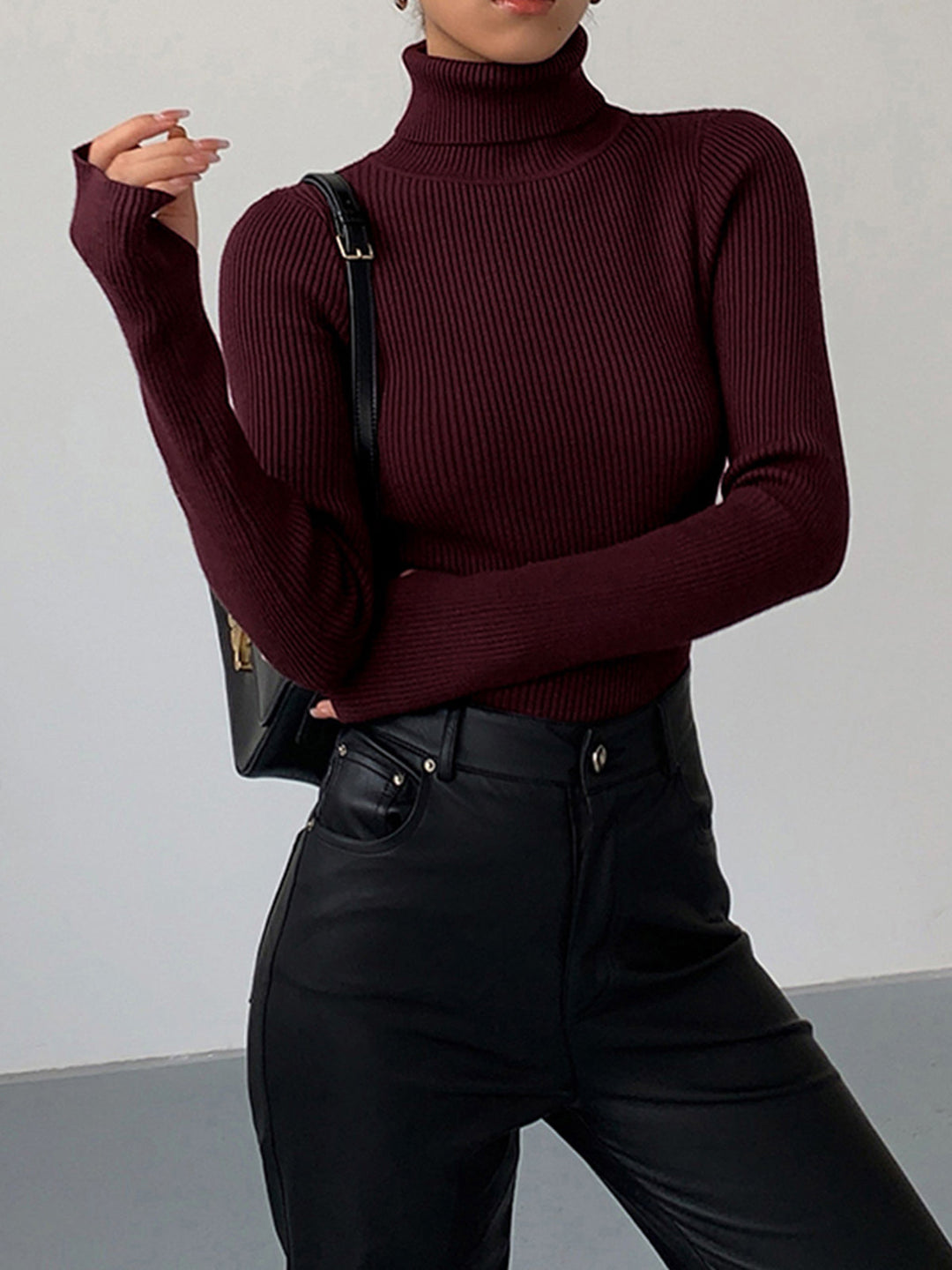Elegant women's ribbed turtleneck sweater in a soft knit, perfect for spring fashion.