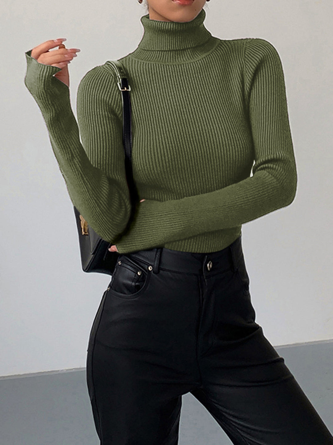 Full shot of a women's ribbed turtleneck sweater, showcasing its length and silhouette for spring.