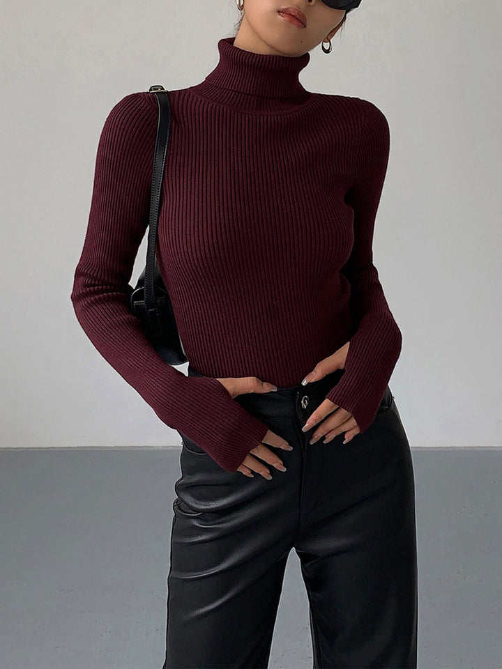Close-up of the ribbed texture on a women's turtleneck spring sweater, emphasizing quality.