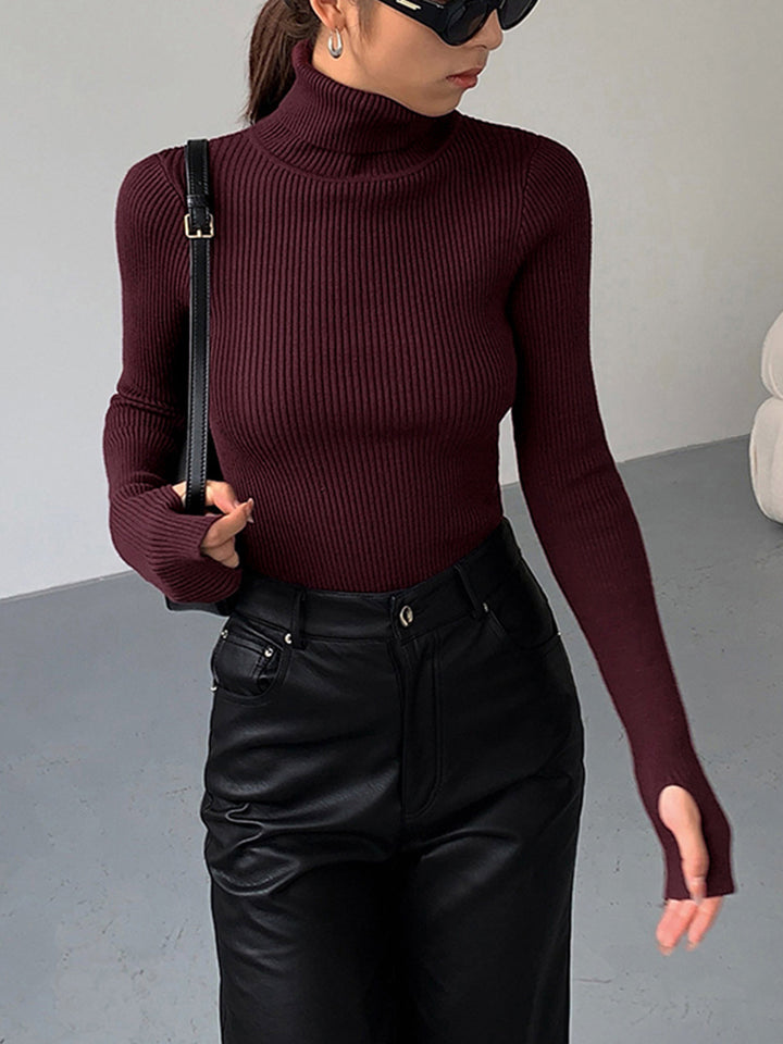 Model wearing a stylish women's ribbed turtleneck sweater, showcasing its elegant fit.