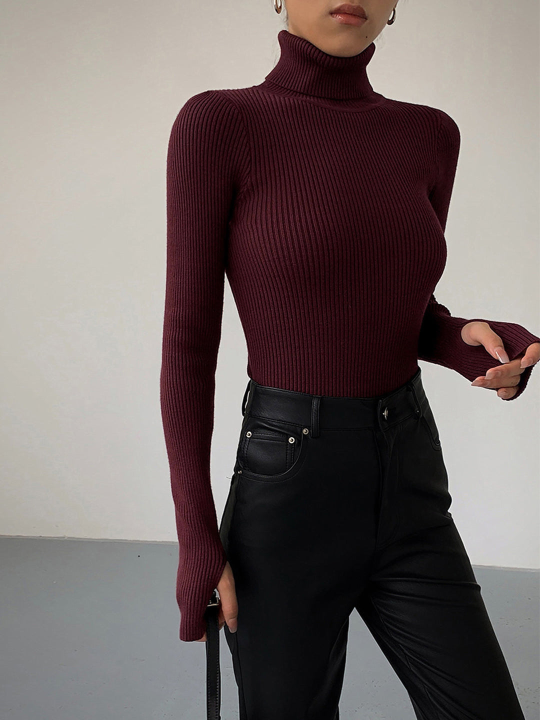Spring fashion women's ribbed turtleneck sweater, ideal for layering or solo wear.