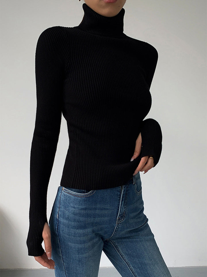Detail of the turtleneck collar on a women's ribbed spring sweater, a key style feature.