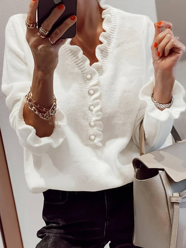 Elegant women's ruffle blouse with decorative gold buttons, perfect for chic office wear or formal events