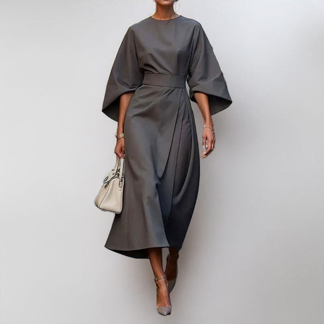 Model wearing an elegant satin feel batwing sleeve maxi dress, showcasing its flowy design.