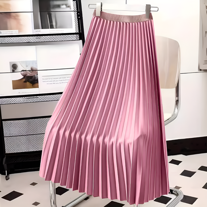 Close-up of a women's satin midi skirt showcasing fine pleats and a high-waist detail, new fashion.